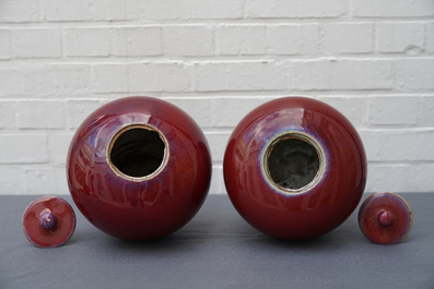 A pair of Chinese monochrome oxblood-glazed jars and covers, 19th C.